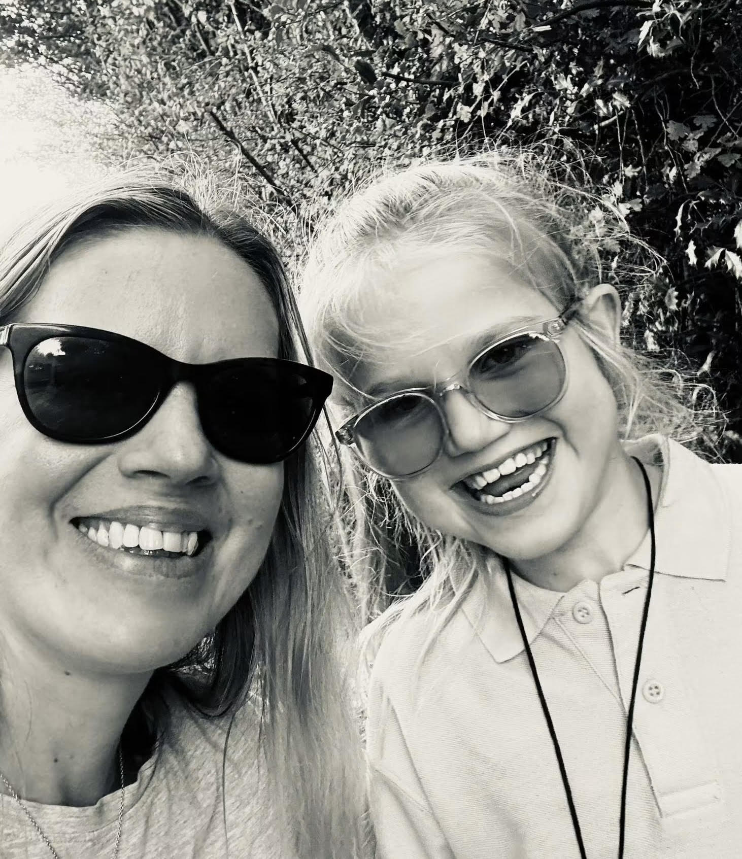 Lydia smiling outdoors with her daughter Bethany.